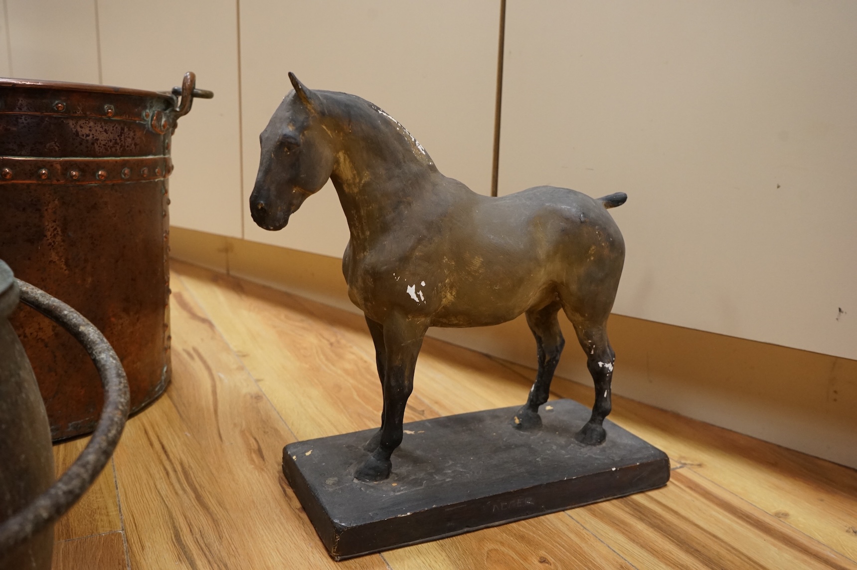 Two copper vessels and a plaster model of a horse
